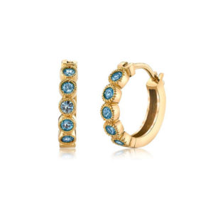 Bezel Huggies in 18k yellow gold set with gray sapphires, by Erica Courtney.