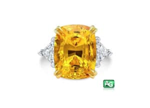 Yellow sapphire flanked by two trillion cut diamonds, by AG Gems.
