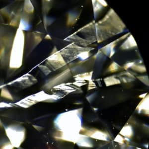 Ribbon-like twinning wisps radiating out from the center of a round brilliant diamond. Twinning wisps are a result of a disruption in the natural growth of a diamond crystal.