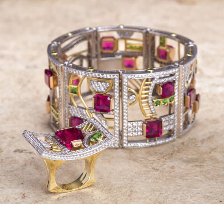 Bracelet and ring created by a collaboration of talent, designed by award-winning designer, Judy Evans. Award-winning lapidary artist, AiVan Pham faceted the rubellite that was mined by Bill Barker. Tsavorite garnets from Bridges Tsavorite and craftmanship done my "Myron and Gary."