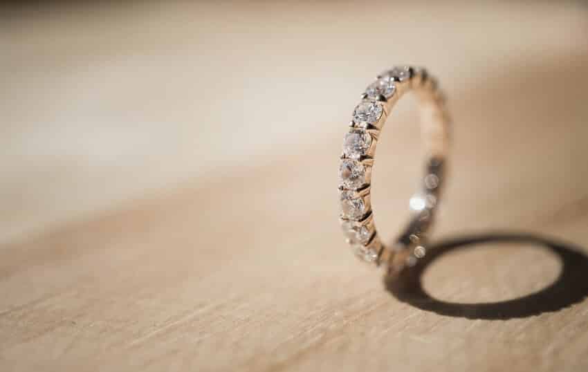 Elegant diamond ring on wooden background