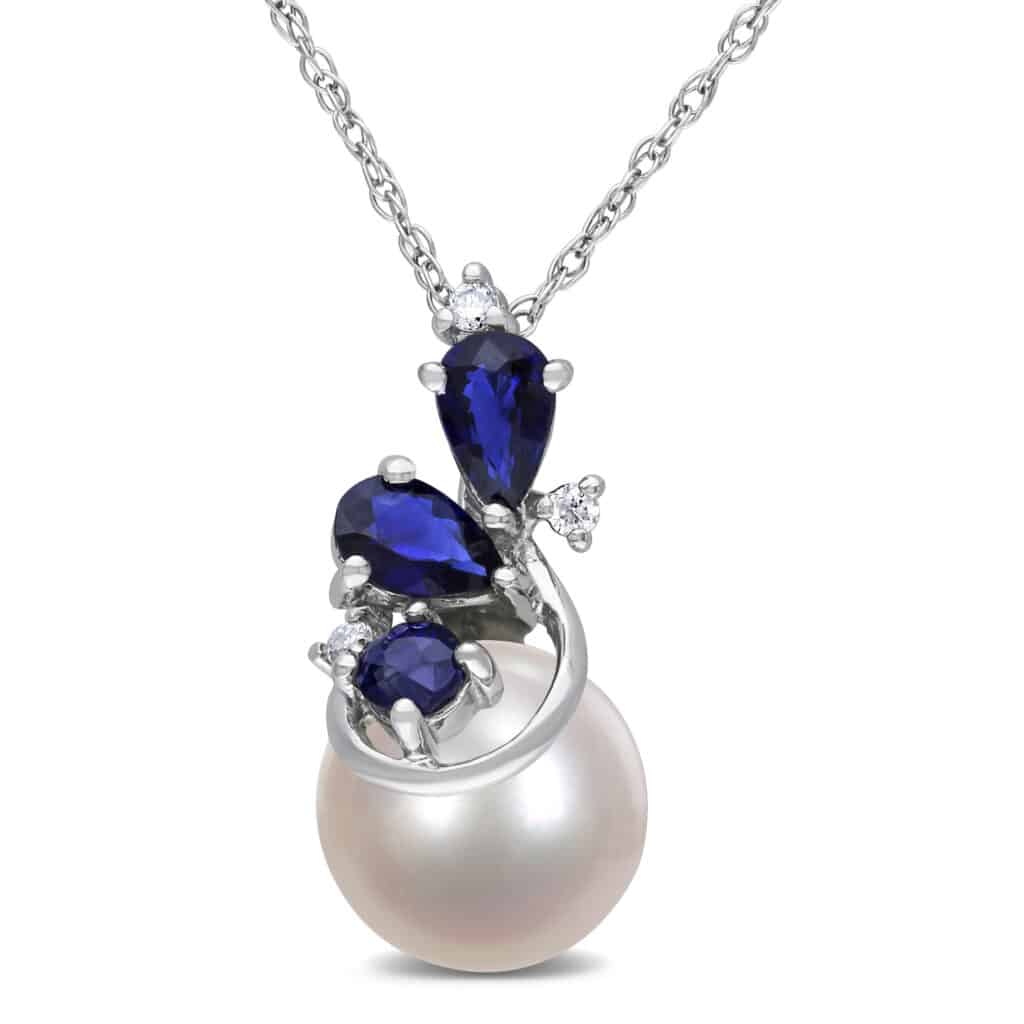 An 8.5–9 MM white cultured freshwater pearl, diamond, and sapphire pendant with chain in 10K white gold.