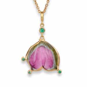 A watermelon tourmaline pendant necklace with emerald accents in gold, by Lika Behar.